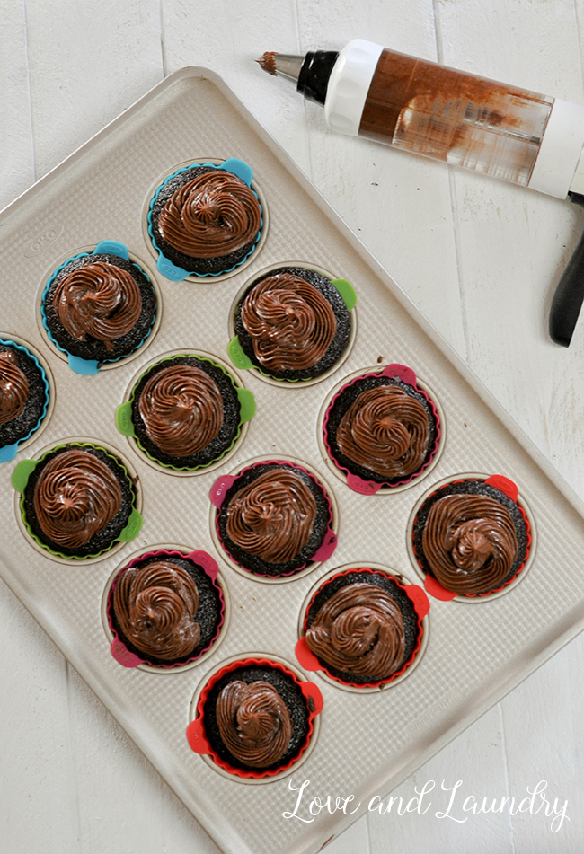 If you are a chocolate lover like me, you'll love these chocolate cupcakes! I bake them for all my kids birthdays. This recipe is for chocolate cake, filled with creamy chocolate ganache, and has a fudgy chocolate frosting and is really easy to bake from scratch! 